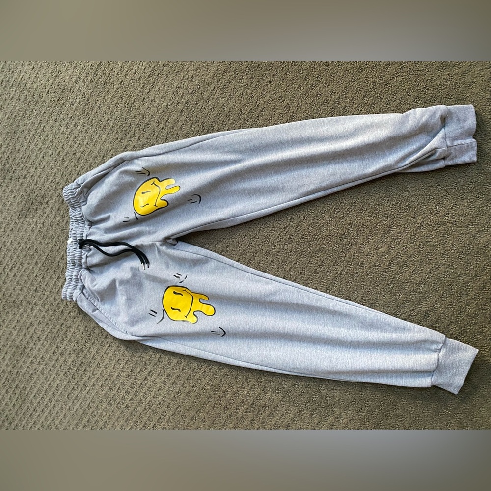 Think grey smiley face sweat pants